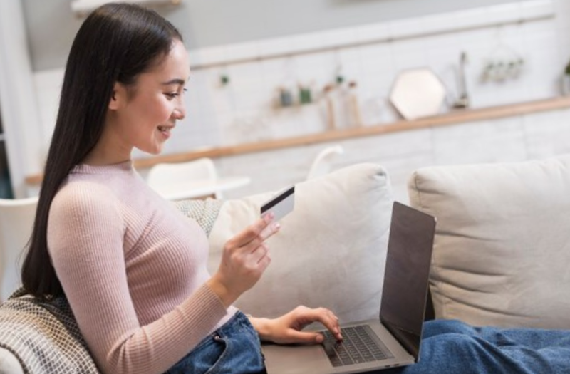woman on sofa shopping online
