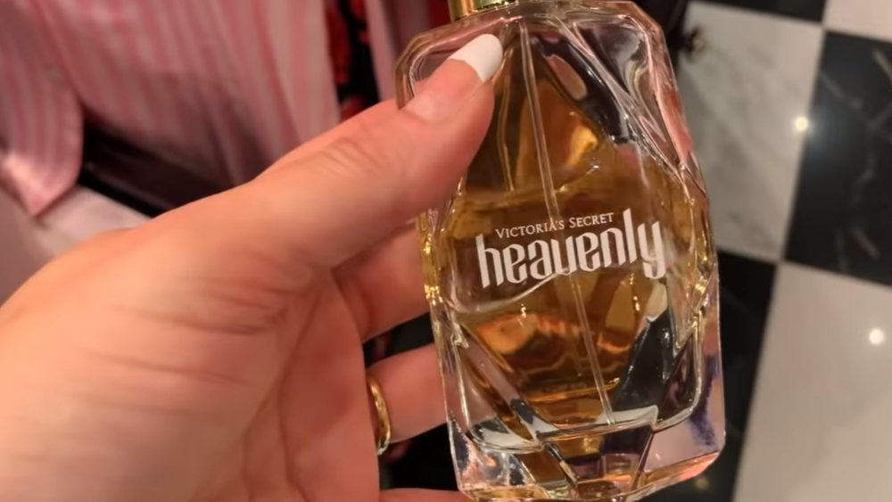 woman's hand with Heavenly perfume by Victoria's Secret