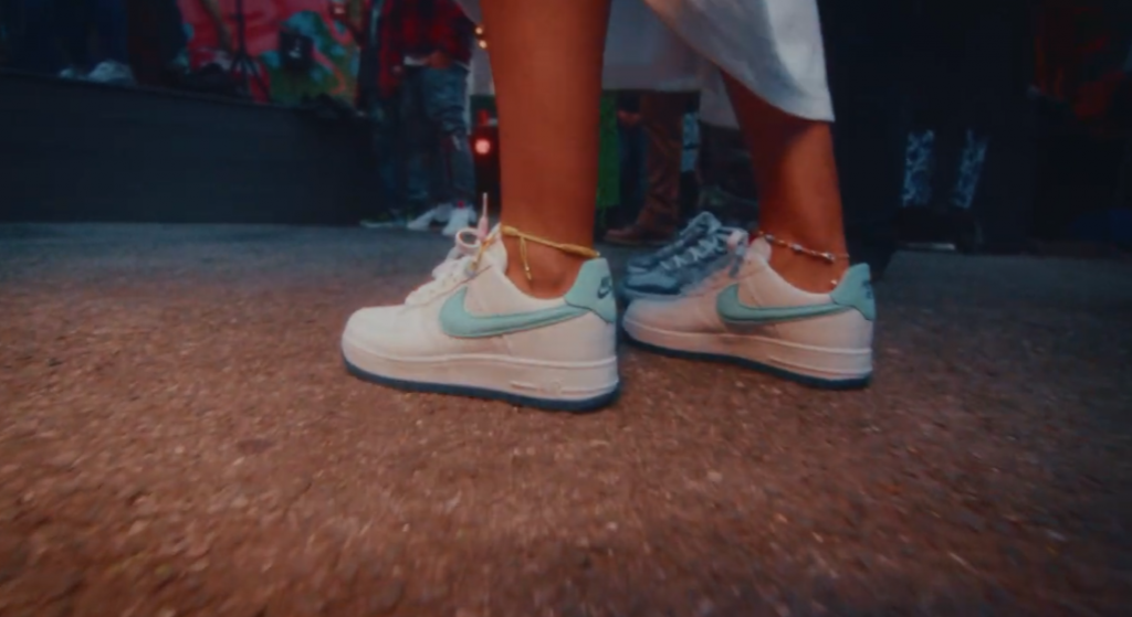 nike Air Force with light blue swoosh on woman feet in the street
