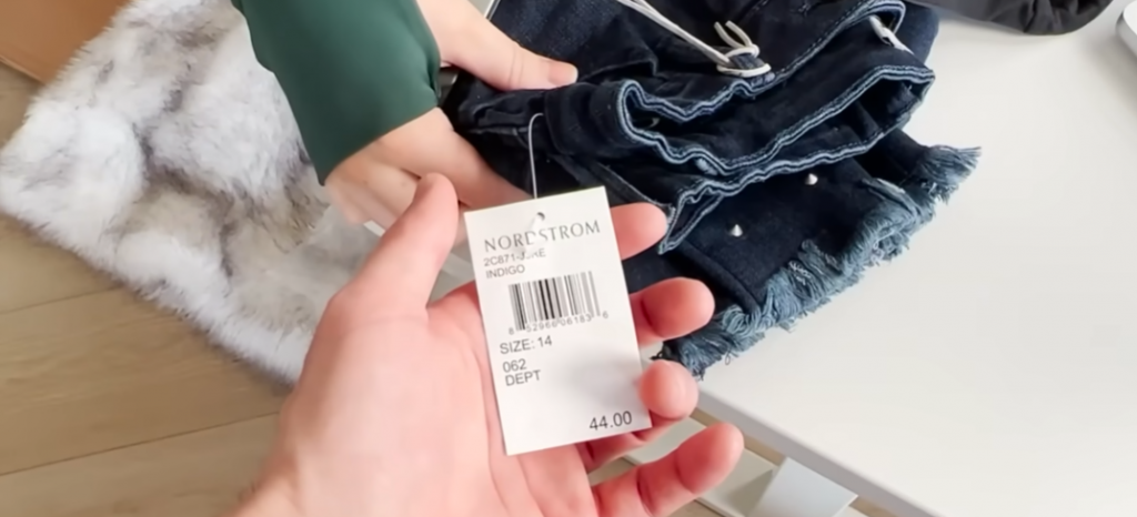 Nordstrom pants and hand showing price tag